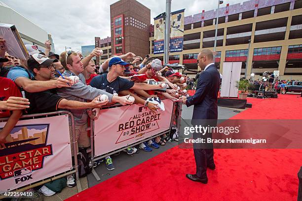 American League All-Star Derek Jeter of the New York Yankees signs autographs in the Red Carpet Parade leading to the 85th MLB All-Star Game at...