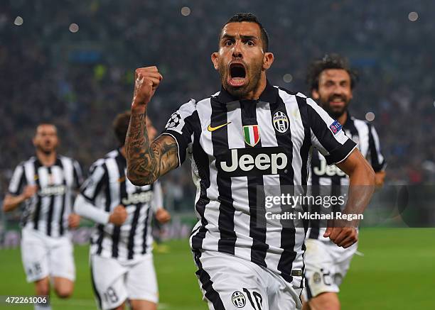 Carlos Tevez of Juventus celebrates as he scores their second goal from a penalty during the UEFA Champions League semi final first leg match between...