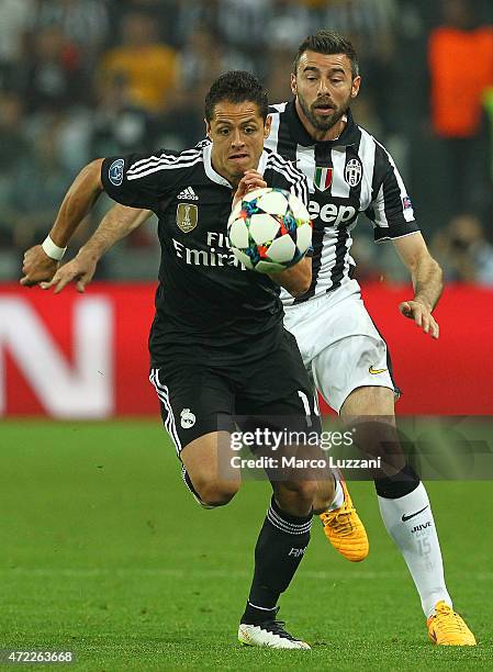 Javier Hernandez of Real Madrid CF competes for the ball with Andrea Barzagli of Juventus FC during the UEFA Champions League semi final match...