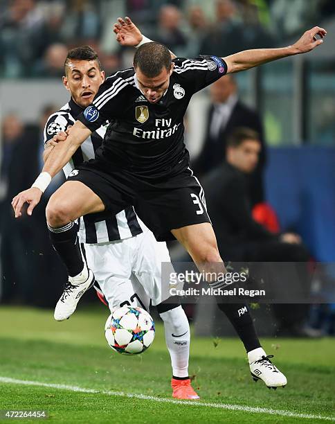 Pepe of Real Madrid CF battles with Roberto Pereyra of Juventus during the UEFA Champions League semi final first leg match between Juventus and Real...