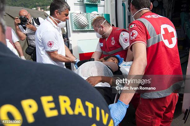 Pregnant woman is taken into care by doctors after disembarking from military ship 'Bettica' following a rescue operation at sea on May 5, 2015 in...