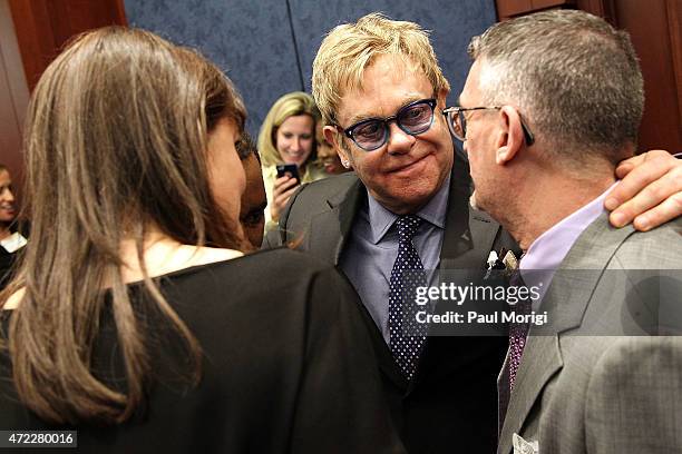 Sir Elton John, Founder, Elton John AIDS Foundation, greets guests at an Elton John AIDS Foundation and The ONE Campaign hosted reception on global...