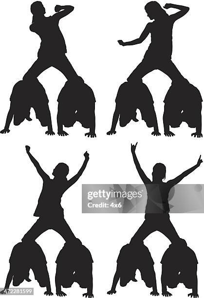 human pyramid girl on top dancing - castell stock illustrations