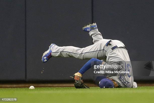 Joc Pederson of the Los Angeles Dodgers misses a catch in center field, allowing a RBI double to Jean Segura in the bottom of the second inning...