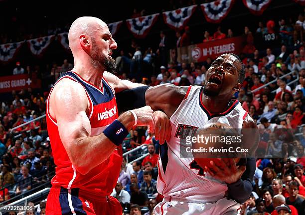 Paul Millsap of the Atlanta Hawks draws a foul from Marcin Gortat of the Washington Wizards during Game Two of the Eastern Conference Semifinals of...