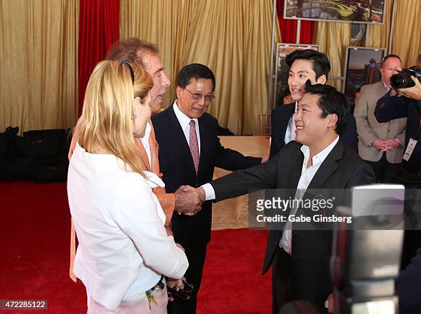 Andrea Hissom and her husband, Wynn Resorts Chairman CEO Steve Wynn are greeted by Chairman and CEO of the Genting Group K.T. Lim, Lim Keong Loui and...