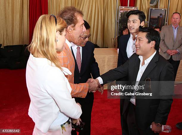 Andrea Hissom and her husband, Wynn Resorts Chairman CEO Steve Wynn are greeted by Chairman and CEO of the Genting Group K.T. Lim, Lim Keong Loui and...