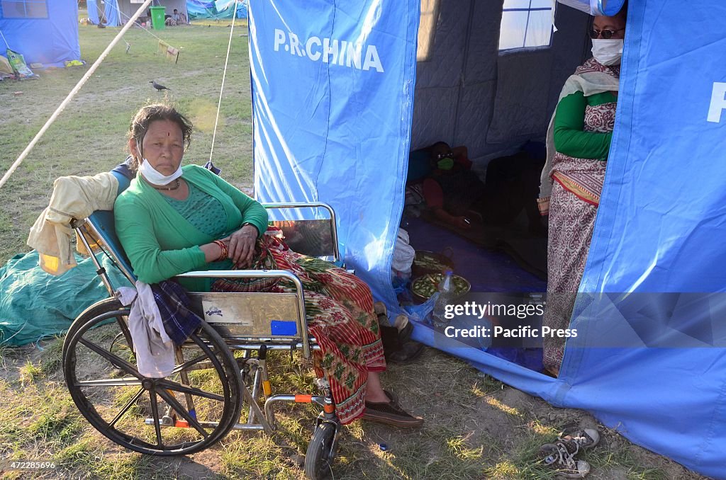 A handicap woman sit outside in her temporary shelter at...