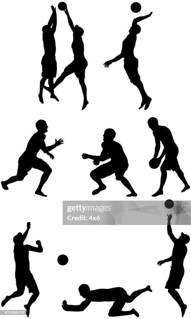 Silhouette of people playing beach volleyball