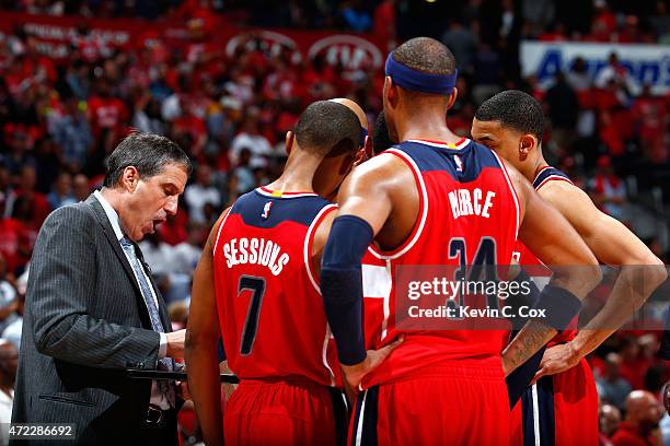 Randy Wittman of the Washington Wizards huddles his players during a timeout against the Atlanta Hawks in Game Two of the Eastern Conference...