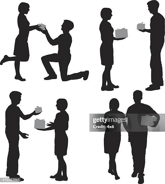 silhouette of people with gifts - man proposing indoor stock illustrations