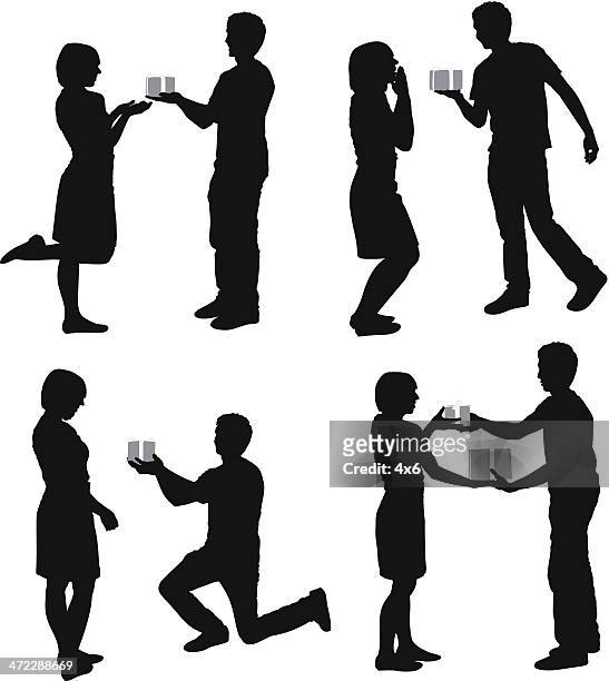 silhouette of couples with gifts - man proposing indoor stock illustrations