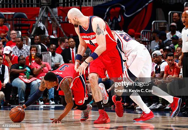 Kyle Korver of the Atlanta Hawks commits a foul as Marcin Gortat of the Washington Wizards sets a screen for Bradley Beal during Game Two of the...