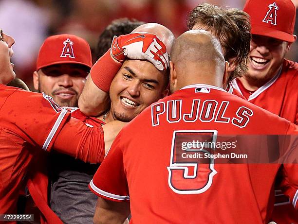 Carlos Perez of the Los Angeles Angels of Anaheim is mobbed by teammates after leading off the ninth inning with a walk off home run to win the game...