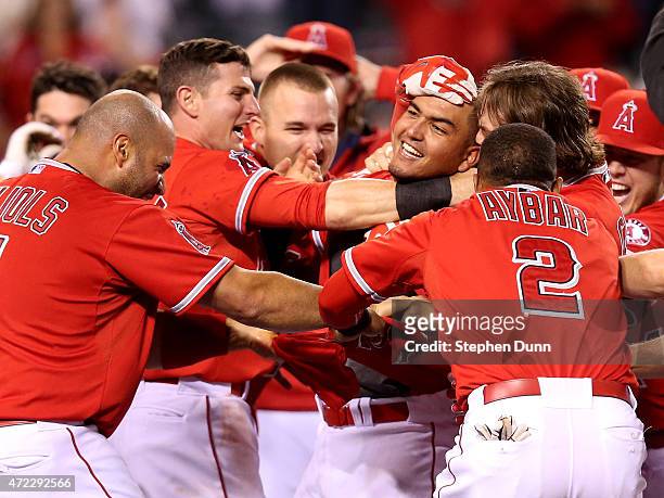 Carlos Perez of the Los Angeles Angels of Anaheim is mobbed by teammates after leading off the ninth inning with a walk off home run to win the game...