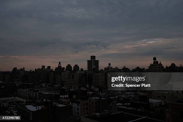 Dark buildings are viewed at dusk in Manhattan on May 5, 2015 in New York City. In an effort to reduce Manhattan's carbon footprint, New York's City...