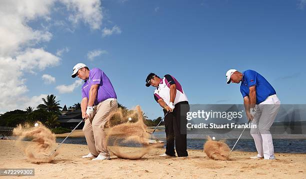 George Coetzee of South Africa, Kiradech Aphibarnrat of Thailand and Thomas Bjorn of Denmark hits shots on the beach prior to the start of the...