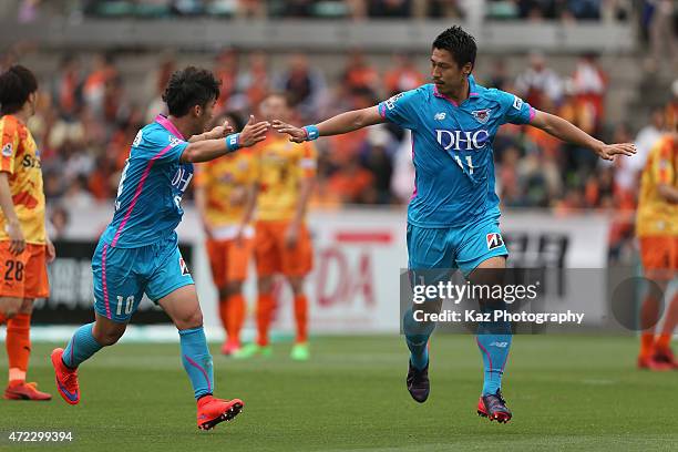 Yohei Toyoda of Sagan Tosu celebrates scoring his team's first goal with his team mate Kim Min-Woo during the J.League match between Shimizu S-Pulse...