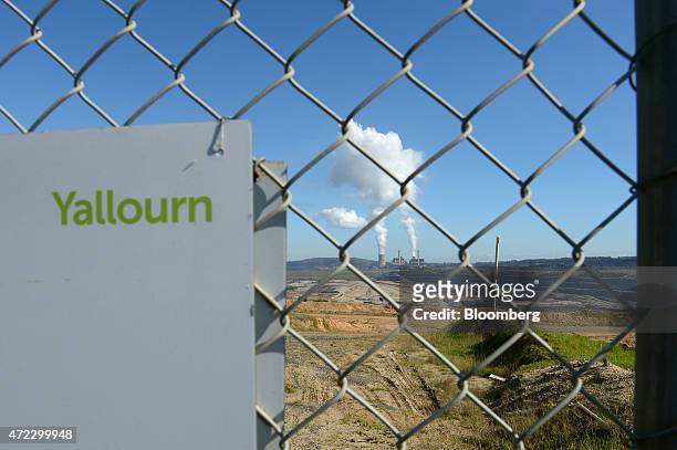 The Yallourn coal-fired power station operated by EnergyAustralia Holdings Ltd., a unit of CLP Holdings Ltd., stands behind a gate as steam billows...
