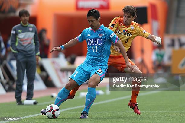 Yohei Toyoda of Sagan Tosu and Dejan Jakovic of Shimizu S-Pulse compete for the ball during the J.League match between Shimizu S-Pulse and Sagan Tosu...