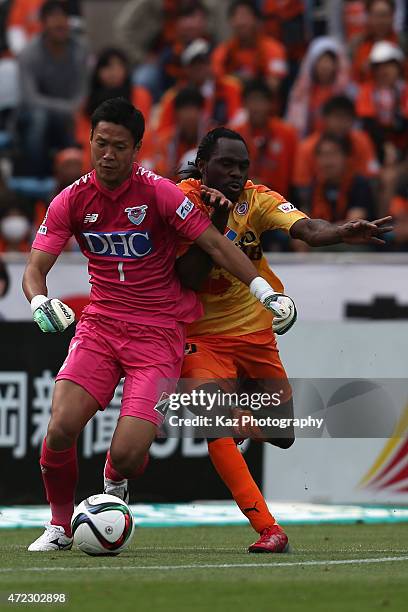 Taku Akahoshi of Sagan Tosu and Peter Utaka of Shimizu S-Pulse compete for the ball during the J.League match between Shimizu S-Pulse and Sagan Tosu...