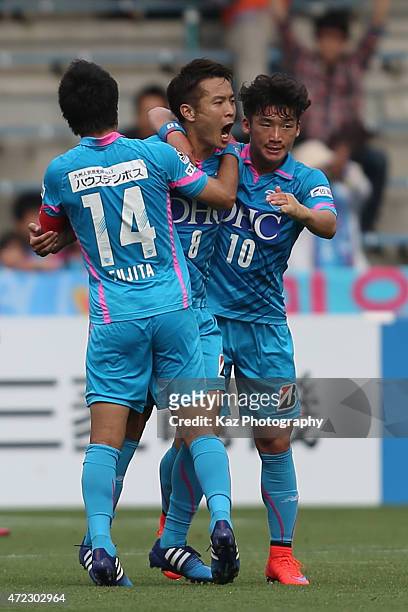 Kota Mizunuma of Sagan Tosu celebrates scoring his team's second goal with his team mates Naoyuki Fujita and Kim Min-Woo during the J.League match...