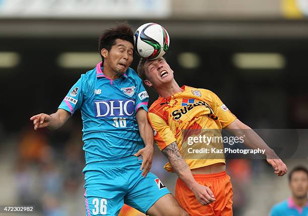 Naoya Kikuchi of Sagan Tosu and Mitchell Duke of Shimizu S-Pulse compete for the ball during the J.League match between Shimizu S-Pulse and Sagan...