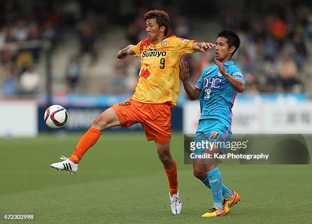 Shun Nagasawa of Shimizu S-Pulse and Hiroyuki Taniguchi of Sagan Tosu compete for the ball during the J.League match between Shimizu S-Pulse and...