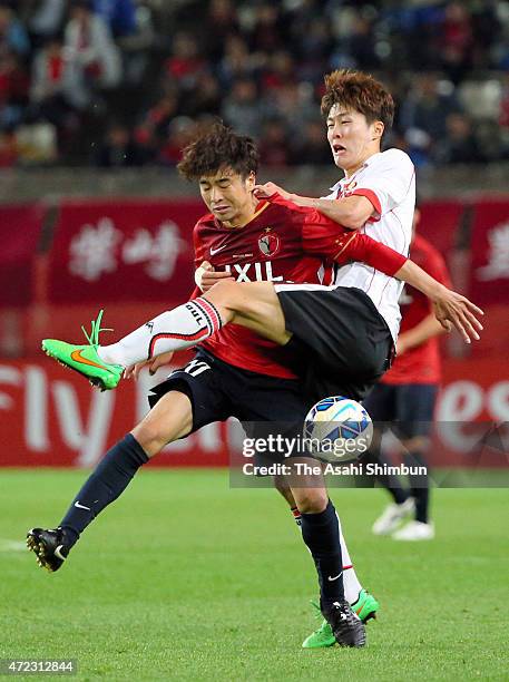 Masashi Motoyama of Kashima Antlers and Koh Myongjin of FC Seoul compete for the ball during the AFC Champions League Group H match between Kashima...