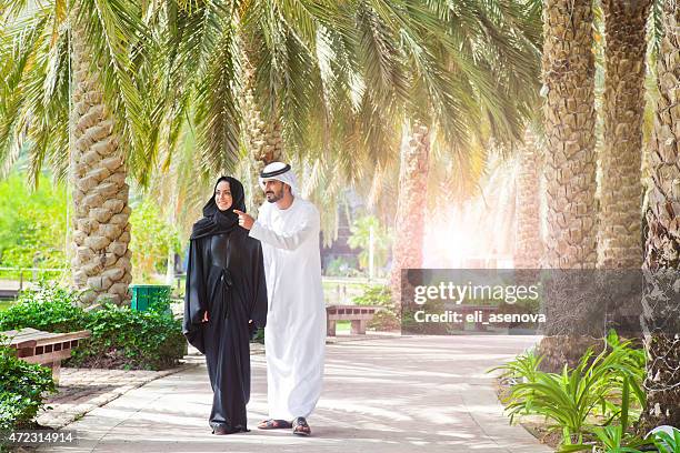 traditional emirati young couple enjoying life outdoor - emirati couple stock pictures, royalty-free photos & images