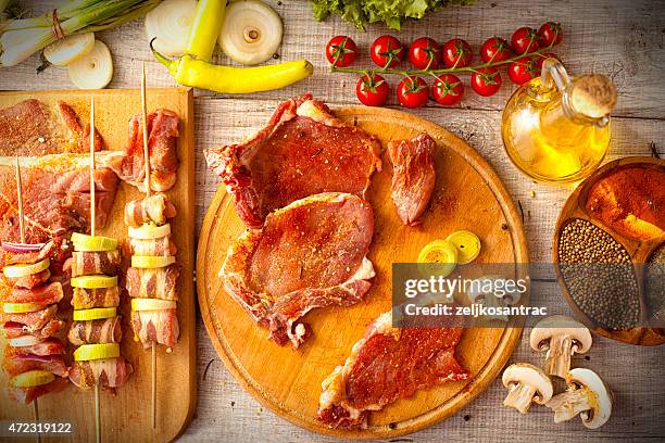 assorted raw meats and vegetables on skewers and platters - marinated stock pictures, royalty-free photos & images