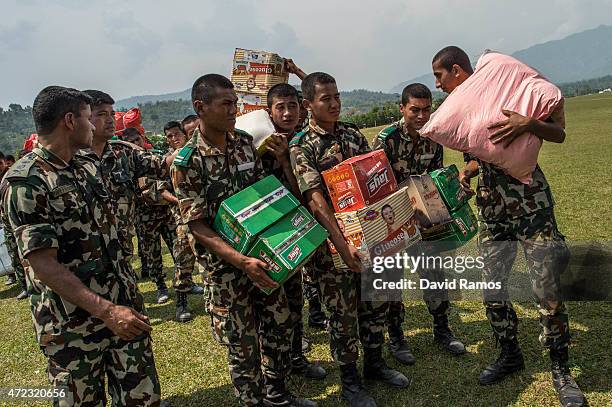 Nepalese soldiers load aid in an Indian Helicopter on May 6, 2015 in Pokhara, Nepal. A major 7.9 earthquake hit Kathmandu mid-day on Saturday 25th...