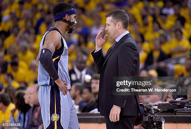 Head Coach David Joerger of the Memphis Grizzlies talks with his player Mike Conley while there's a break in the action against the Golden State...