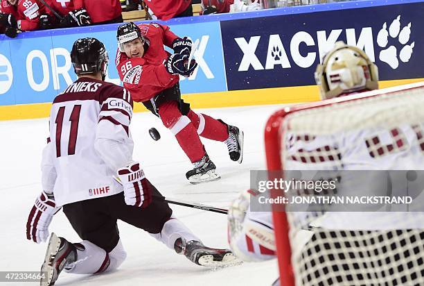 Forward Damien Brunner of Switzerland shoots the puck during the group A preliminary round match Switzerland vs Latvia at the 2015 IIHF Ice Hockey...