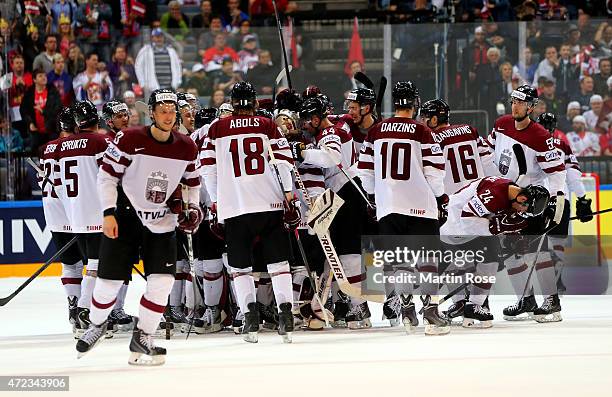 The team of Latvia celebrate after winning the IIHF World Championship group A match between Switzerland and Latvia at o2 Arena on May 6, 2015 in...
