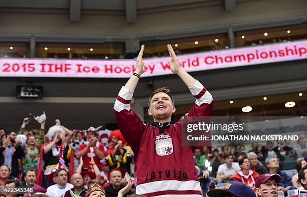 Latvian ice hockey supporter cheers his team during the group A preliminary round match Switzerland vs Latvia at the 2015 IIHF Ice Hockey World...