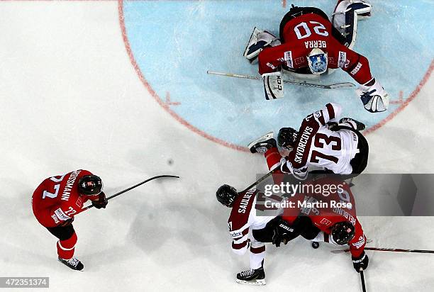 Players of Switzerland and of Latvia battle for the puck in front of the net during the IIHF World Championship group A match between Switzerland and...