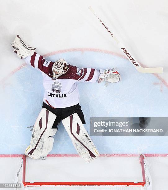 Goalkeeper Edgars Masalskis of Latvia falls during the group A preliminary round match Switzerland vs Latvia at the 2015 IIHF Ice Hockey World...