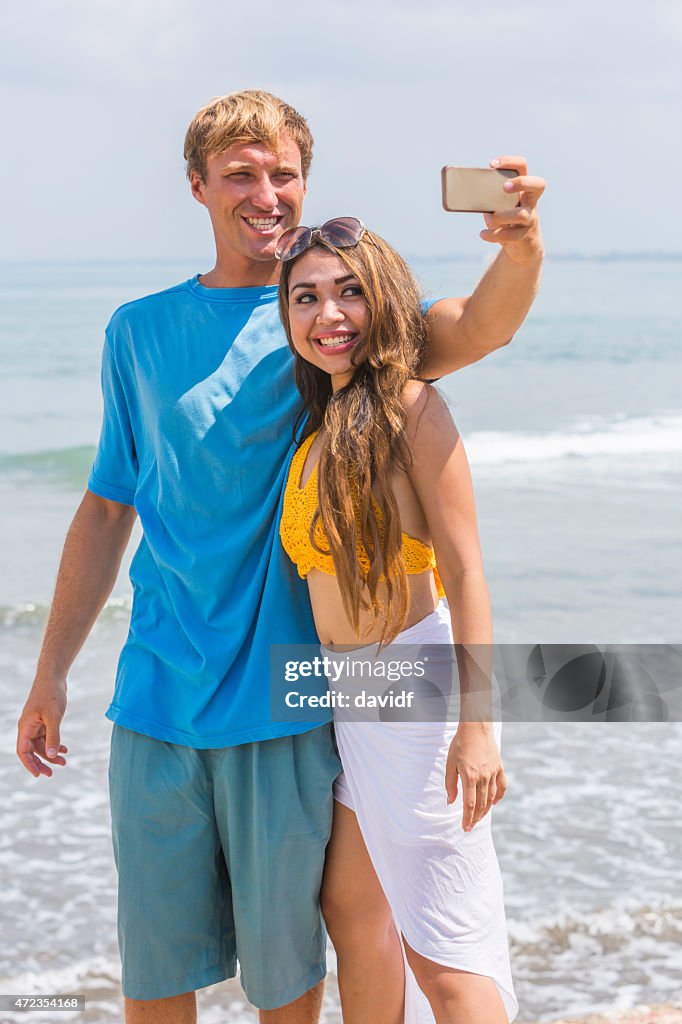 Young Happy Couple Taking Selfie Self Portraits at the Beach
