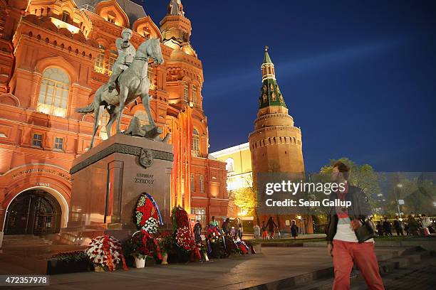 People walk past a statue of World War II Russian General Georgy Zhukov, who led Soviet Red Army forces in the final push to attack Berlin in 1945,...