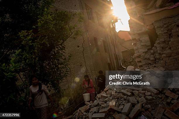 People walk through rubble in Shanku on May 6, 2015 in Kathmandu, Nepal. A major 7.9 earthquake hit Kathmandu mid-day on Saturday 25th April, and was...