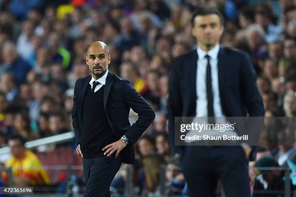 Dejected Josep Guardiola the head coach of Bayern Muenchen looks on past Luis Enrique the head coach of Barcelona during the UEFA Champions League...