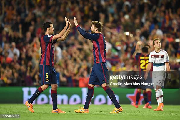 Sergio Busquets of Barcelona and Gerard Pique of Barcelona celebrate following their team's 3-0 victory during the UEFA Champions League Semi Final,...