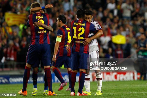 Barcelona's midfielder Rafinha hugs his brother Bayern Munich's Spanish midfielder Thiago Alcantara at the end of the UEFA Champions League football...