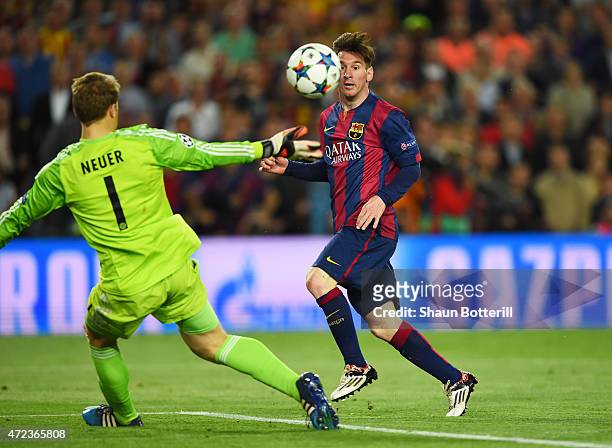 Lionel Messi of Barcelona chips the ball over goalkeeper Manuel Neuer of Bayern Muenchen to score his team's second goal during the UEFA Champions...