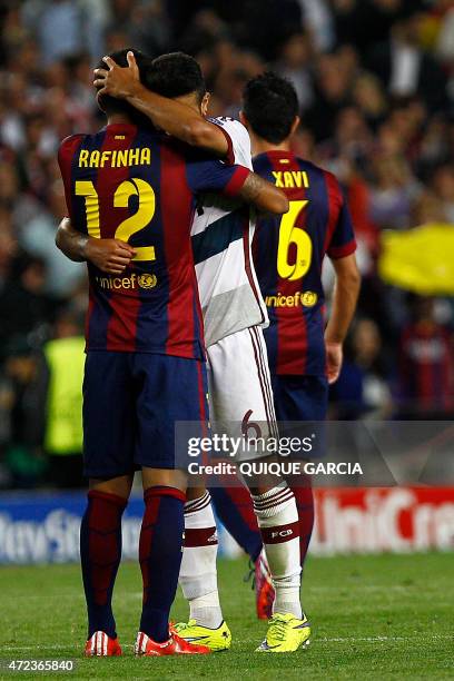 Barcelona's midfielder Rafinha hugs his brother Bayern Munich's Spanish midfielder Thiago Alcantara during the UEFA Champions League football match...