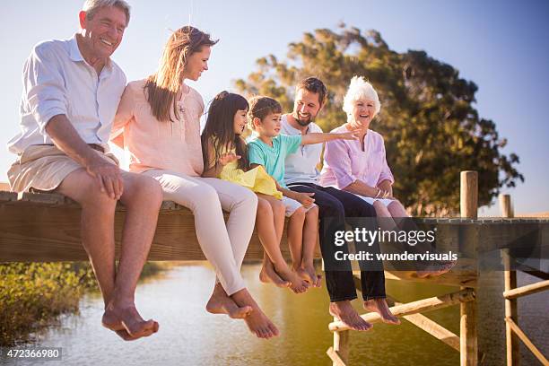 three generation family enjoying a summer vacation together - multi generation family summer stock pictures, royalty-free photos & images