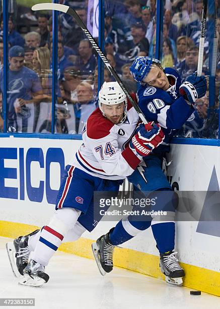 Vladislav Namestnikov of the Tampa Bay Lightning is checked by Alexei Emelin of the Montreal Canadiens during the third period in Game Three of the...