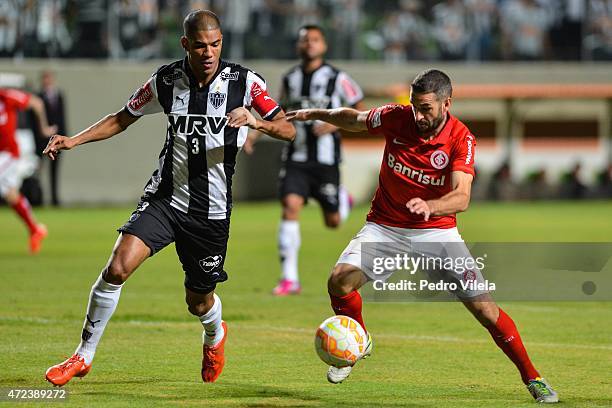 Leonardo Silva of Atletico MG and Lisandro Lopez of Internacional battle for the ball during a match between Atletico MG and Internacional as part of...