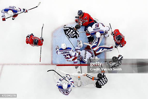 Goalie Henrik Lundqvist of the New York Rangers lays on his back after making a save on Joel Ward of the Washington Capitals during the third period...